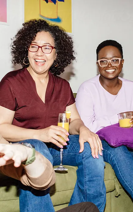 Target customer image: Curly haired woman in 30-40s at a house party